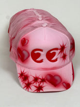 Load image into Gallery viewer, cc heart eyes hat by jimmy guiterrez
